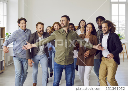 Group of a happy smiling business people having fun and greeting their leader in office. 131361052