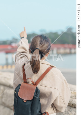Woman tourist sightseeing Fukuura jima bridge or the bridge of romantic encounters for Fukuura Island at Matsushima Bay in Matsushima, Miyagi Prefecture, Tohoku, Japan. Landmark and famous Vacation 131361201