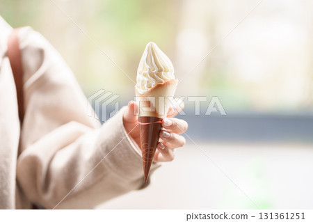 Woman tourist holds ice cream during sightseeing Sakura Cherry Blossom. traveler travel in Samurai village in Kakunodate town, Semboku District, Akita Prefecture, Japan. Landmark and vacation 131361251