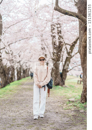 Woman tourist sightseeing Sakura Cherry Blossom in Spring. Happy traveler travel near Hinokinai River riverbank in Kakunodate town, Semboku District, Akita Prefecture, Japan. Landmark and Vacation Woman tourist sightseeing Sakura Cherry Blossom in Spring. Happy traveler travel near Hinokinai River riverbank in Kakunodate town, Semboku District, Akita Prefecture, Japan. Landmark and Vacation 131361255