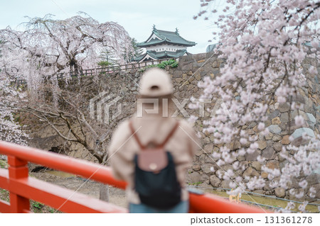Woman tourist sightseeing Hirosaki Castle with Sakura Cherry Blossom in Spring, happy traveler travel in Hirosaki city, Aomori, Tohoku, Japan. Landmark famous in Japan. Travel and Vacation destination Woman tourist sightseeing Hirosaki Castle with Sakura Cherry Blossom in Spring, happy traveler travel in Hirosaki city, Aomori, Tohoku, Japan. Landmark famous in Japan. Travel and Vacation destination 131361278