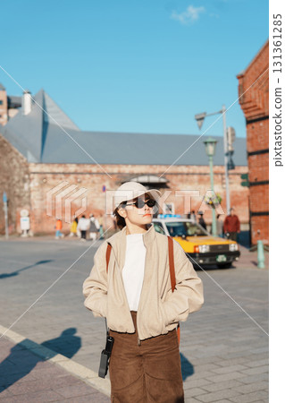 Woman tourist Visiting in Hakodate, happy Traveler sightseeing Kanemori Red Brick Warehouse in spring season. landmark and popular for attractions in Hokkaido, Japan. Travel and Vacation concept 131361285