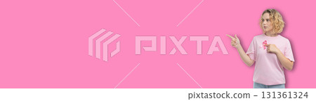 Woman promotes cancer awareness through a pink ribbon sign 131361324
