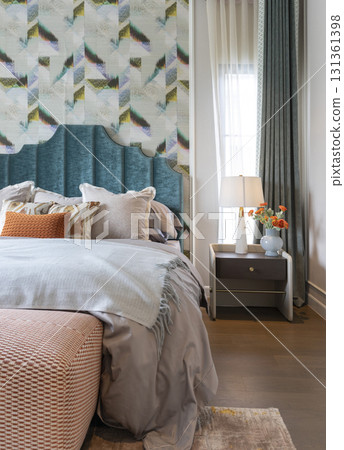 Interior view of luxury decorated green and blue bedroom with side table lamp. 131361398