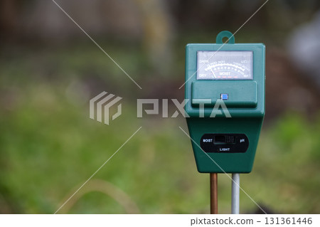 Green Moisture Meter in Outdoor Garden Monitoring Soil and Light for Plant Health Green Moisture Meter in Outdoor Garden Monitoring Soil and Light for Plant Health 131361446