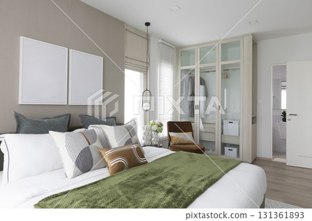 Modern bedroom interior with gray and green bedding. Picture frame on wall. Modern bedroom interior with gray and green bedding. Picture frame on wall. 131361893