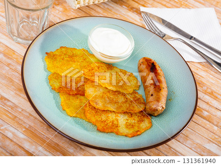 Potato pancakes with sausage and sour cream Potato pancakes with sausage and sour cream 131361940