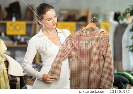 During November sales, woman choose and buy warm knitted dress 131361985