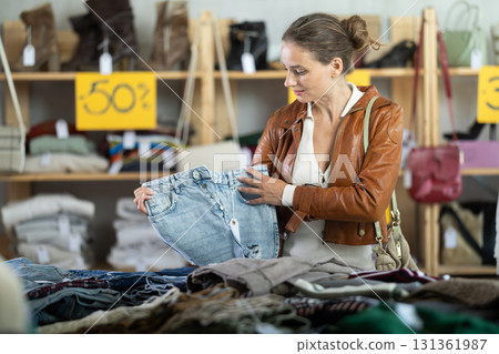 Woman choosing jeans in a store 131361987