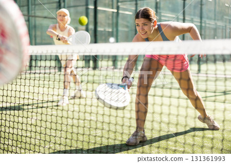 Young woman playing Padel Tennis in open-air tennis court Young woman playing Padel Tennis in open-air tennis court 131361993