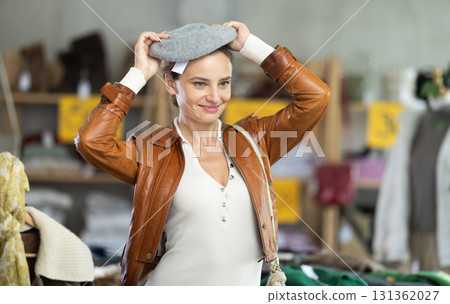 woman chooses a warm hat 131362027