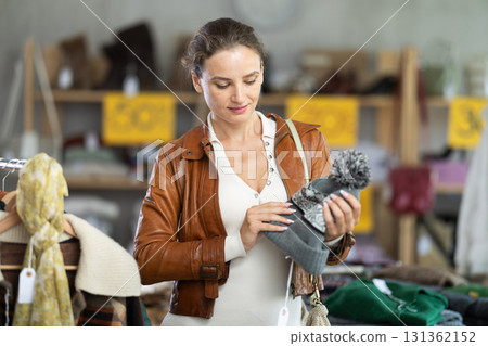During November sales, woman choose and buy hat During November sales, woman choose and buy hat 131362152