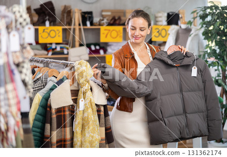During November sales, woman choose and buy down jacket 131362174