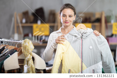 During November sales, woman choose and buy coat During November sales, woman choose and buy coat 131362221