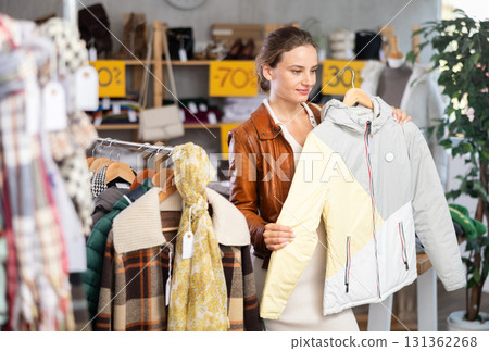 During November sales, woman choose and buy coat During November sales, woman choose and buy coat 131362268