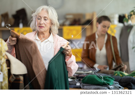 During November sales, mature woman choose and buy warm knitted dress During November sales, mature woman choose and buy warm knitted dress 131362321