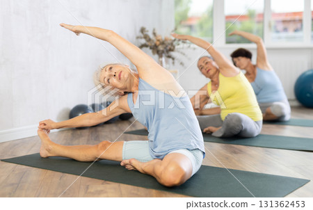 Group of elderly woman doing yoga on mat in studio 131362453