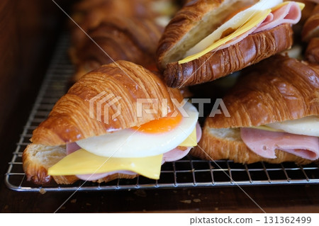 Ham cheese scrambled eggs croissant for breakfast. toning Ham cheese scrambled eggs croissant for breakfast. toning 131362499