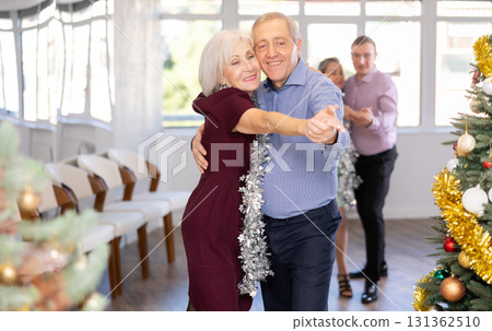 In studio decorated for New Year, elderly man and woman perky dance pair discofox. In studio decorated for New Year, elderly man and woman perky dance pair discofox. 131362510