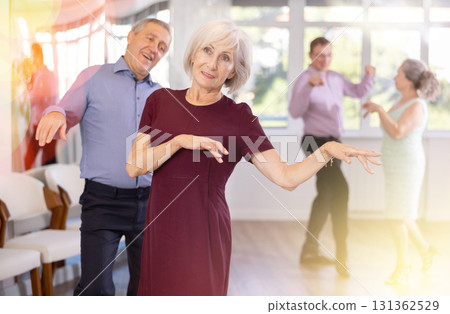 Senior man and elderly woman are dancing contemporary twist in couple 131362529