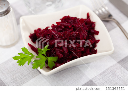 Popular russian salad, made from boiled grated beetroot, decorated with herbs Popular russian salad, made from boiled grated beetroot, decorated with herbs 131362551