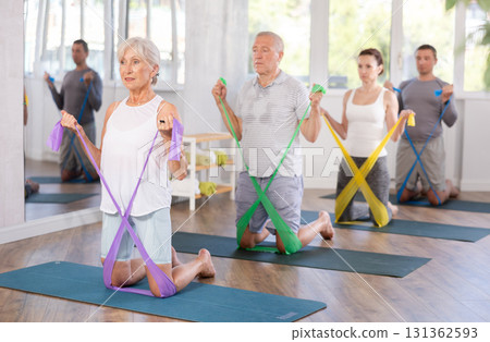 Elderly woman exercises with pilates band 131362593