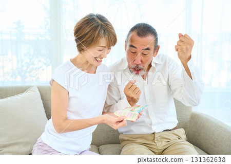 Seniors looking at the results of lottery tickets 131362638
