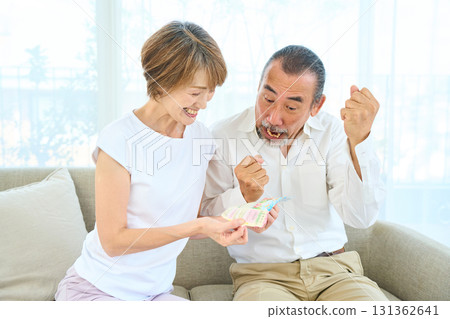 Seniors looking at the results of lottery tickets Seniors looking at the results of lottery tickets 131362641