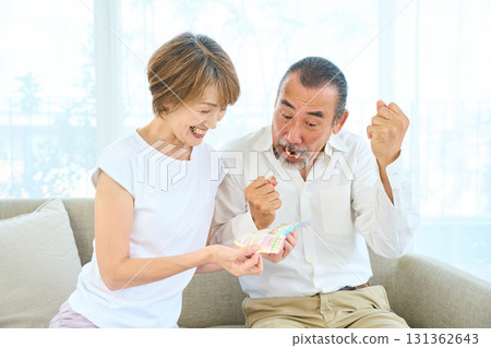 Seniors looking at the results of lottery tickets 131362643