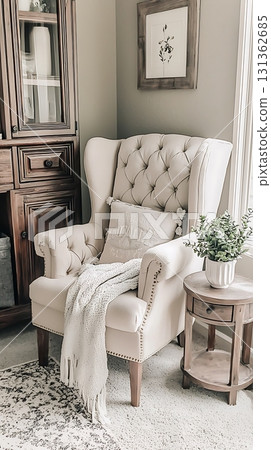 Chair with a white pillow and a blanket on it 131362685