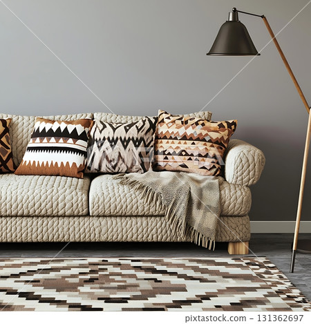 Couch with a brown and white throw blanket and pillows on it 131362697