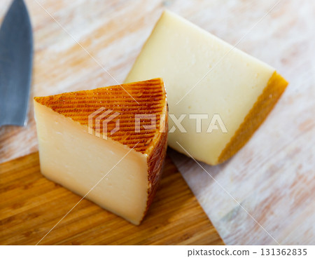 Slices of traditional spanish semi-hard cheese from milk of sheep Slices of traditional spanish semi-hard cheese from milk of sheep 131362835