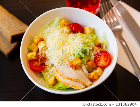 Fresh Caesar salad with chicken on plate 131362904