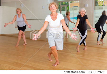 Mature dancing woman practices energetic swing 131362928