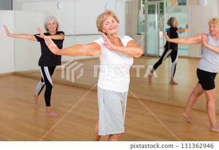 Active elderly lady learning modern dynamic dances in choreography class 131362946