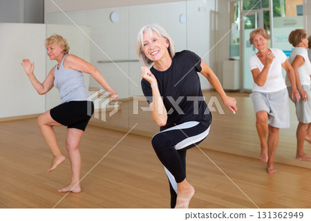 Active mature woman learning dynamic dances in choreography class 131362949