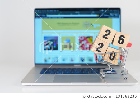 Happy new year with 2026 block in shopping trolley cart on table. E commerce, online shopping, finance, consumer economy and celebration concepts 131363239