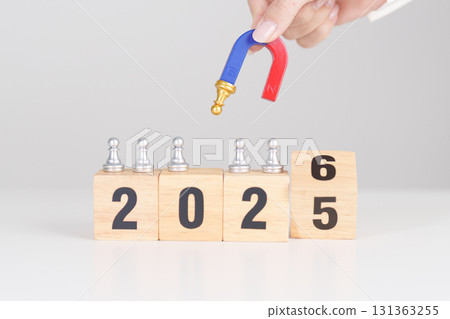 hand holding magnet and pulling man chess figure from the crowd employee with 2026 Year block. Human resource management, Recruitment, Teamwork, strategy, toxic people and leadership Concepts 131363255