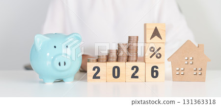 2026 New Year with percentage change to UP and Down arrow, Home model and coin stack. Real estate Mortgage, Refinance, House loan and debt, Interest rate, Insurance, Financial and Property Tax 131363318