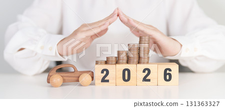 Happy New Year 2026 with hand cover money stack. car Insurance, Financial, vehicle Repair and Maintenance, Automobile Tax. Money Saving and New Year concept 131363327