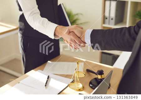 Lawyer and Client Handshake after Contract Signing in Office 131363849