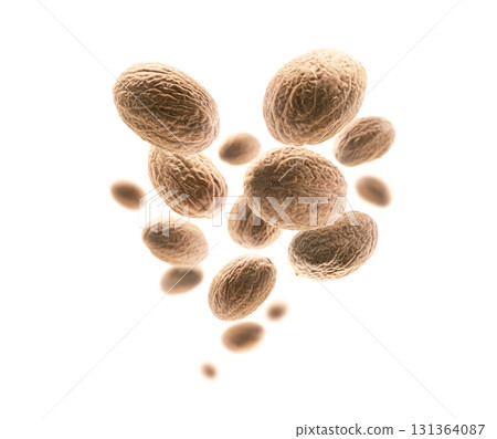 Ripe nutmegs levitate on a white background Ripe nutmegs levitate on a white background 131364087