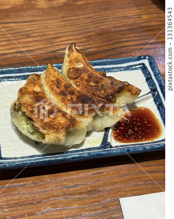 Delicious Korean mandu dumplings with a golden, crispy exterior and flavorful filling. Perfect as an appetizer, snack, or side dish, offering a delightful taste in every bite. Delicious Korean mandu dumplings with a golden, crispy exterior and flavorful filling. Perfect as an appetizer, snack, or side dish, offering a delightful taste in every bite. 131364543