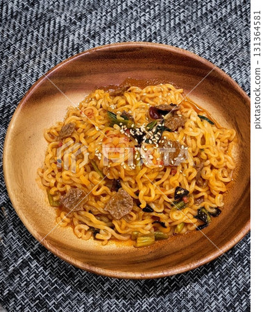 Spicy and flavorful buldak topped with melted cheddar cheese, creating a rich and creamy contrast to the intense heat. A perfect balance of bold spice and cheesy indulgence for a satisfying meal. 131364581