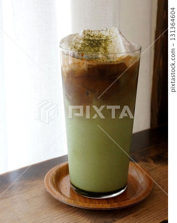 A creamy iced matcha latte with vibrant green tea and smooth milk. Perfectly chilled for a refreshing and energizing drink, offering a balance of earthy matcha and light sweetness. 131364604
