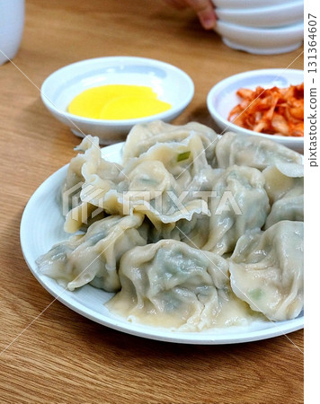 Steamed or fried Korean mandu dumplings filled with a savory mix of meat and vegetables. Crispy on the outside, tender on the inside. perfect for dipping in soy sauce or chili oil! 131364607