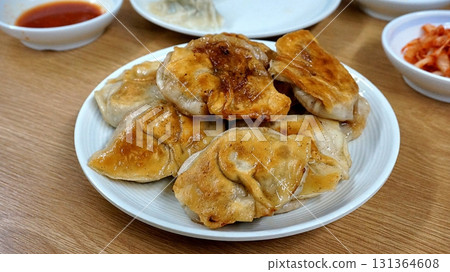 Steamed or fried Korean mandu dumplings filled with a savory mix of meat and vegetables. Crispy on the outside, tender on the inside. perfect for dipping in soy sauce or chili oil! Steamed or fried Korean mandu dumplings filled with a savory mix of meat and vegetables. Crispy on the outside, tender on the inside. perfect for dipping in soy sauce or chili oil! 131364608