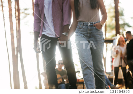 Couple is walking forward. Group of friends are having fun together in the forest 131364895