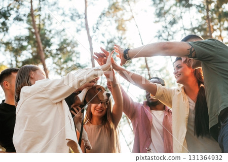 With dog. Group of friends are having fun together in the forest With dog. Group of friends are having fun together in the forest 131364932