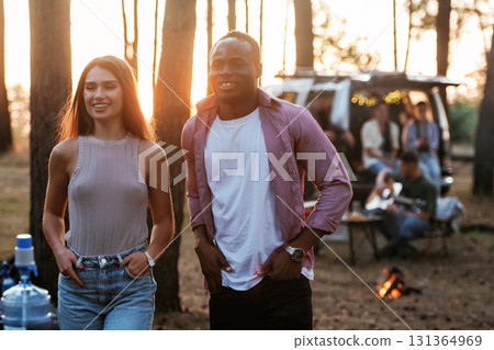 Couple is walking forward. Group of friends are having fun together in the forest 131364969
